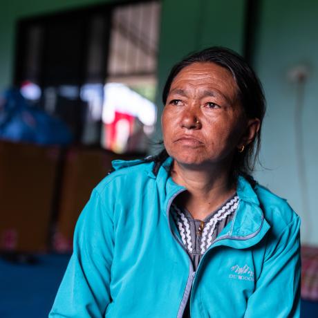 Dawasang at a holding centre in Tupche, Nepal. She lost her husband in the floods and worries about her children’s future.
