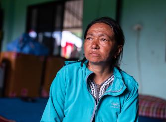 Dawasang at a holding centre in Tupche, Nepal. She lost her husband in the floods and worries about her children’s future.